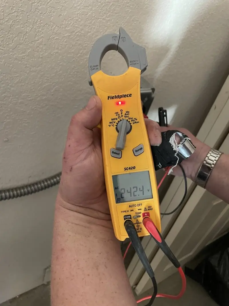 Voltage testing with clamp meter during Outlet Installation in Tamarac